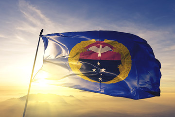 Gulf province of Papua New Guinea flag waving on the top sunrise mist fog