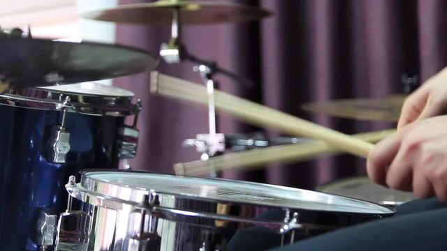 Drummer plays the rhythm on the snare drum. Close-up