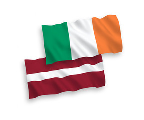 National vector fabric wave flags of Latvia and Ireland isolated on white background. 1 to 2 proportion.