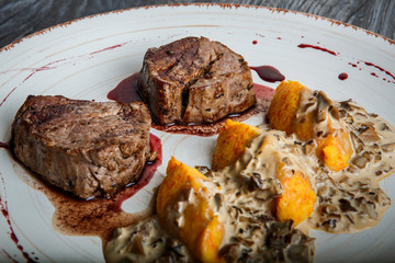 closeup grilled meat steak with blood with potato zrazy garnish