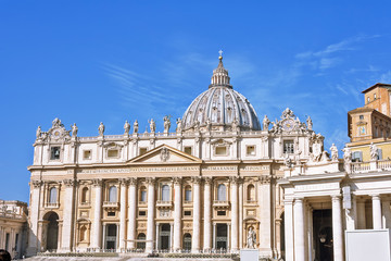 Fototapeta na wymiar VATICAN CITY, VATICAN, Italy - March 2019: Fragments of the Papal Basilica of St. Peter (San Pietro Piazza) in the Vatican and columns on Saint Peter`s square in Rome