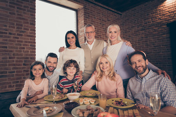Close up photo adorable affectionate people big family funny company brother sister granny mom grandpa son daughter dad father sit close festive holiday tasty eat dishes table loft house indoors
