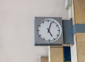 Black and white clock with metal frame on the wall