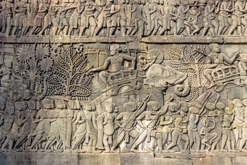 Carving on stone wall in Khmer temple at Angkor Wat in Cambodia 