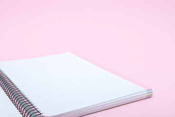 Notebook on pink background, lifestyle concept, top view.