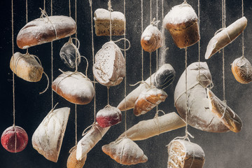 flour falling at fresh homemade bread and pastry hanging on ropes