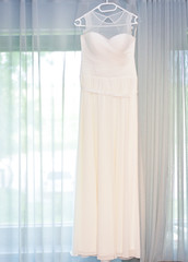window with curtains and wedding dress