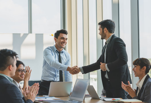 Business people shaking hands congratulations to work success