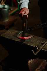 close up of a blacksmith working with hot metal