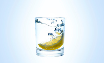 Lemon splashes in a water glass