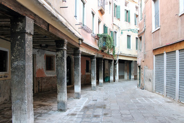Fototapeta na wymiar Gallery with columns in the street Venice Italy