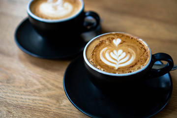 cup of cappucino on wooden table