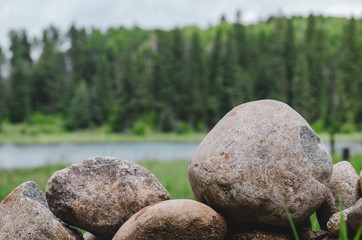 Rocks piled up near a lake in Manitoba