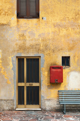 Fototapeta na wymiar Facade of old house with front door and bench, outdoors