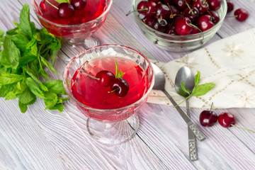 Jelly from a sweet cherry on a wooden background
