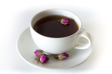 Cup of roses tea with rose