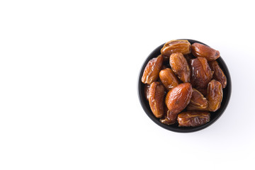 Dates in black bowl isolated on white background. Top view. Copyspace