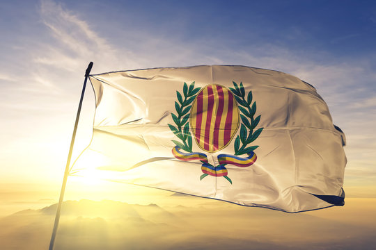 Sant Julia de Loria parish of Andorra flag waving on the top sunrise mist fog