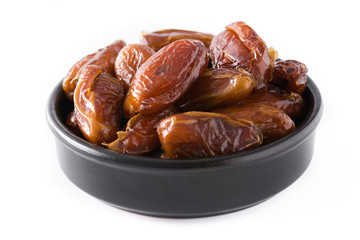 Dates in black bowl isolated on white background