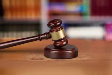 Wooden gavel on wooden table, on  background