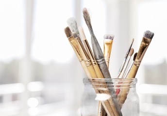 Row of artist paint brushes  on background