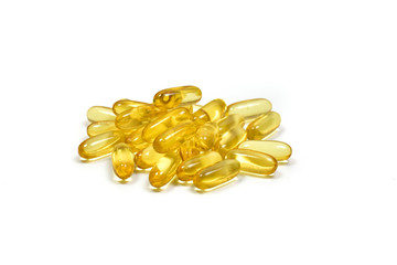 Close up to Golden Pile fish oil capsules isolated on white background. Salmon fish capsules view. Omega 3. Vitamin E. Supplementary food for good health.