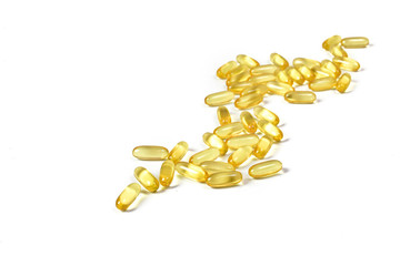 Close up to Gold fish oil capsules isolated on white background. Omega 3. Vitamin E. Salmon fish capsules. Supplementary food background.