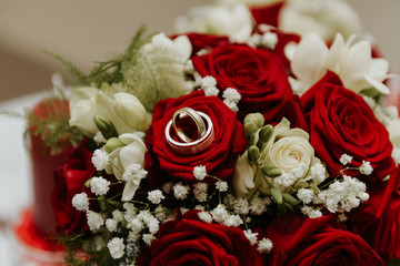wedding rings in bouquet of roses