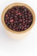 red beans in a wooden plate on a white background