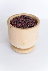 red beans in a wooden plate on a white background
