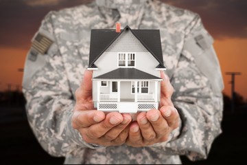 Soldier Holding a Model of House