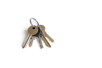 Several keys on a white isolated background, the keys to the apartment.
