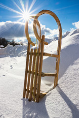 Sledge in the snow, sun stars in the background