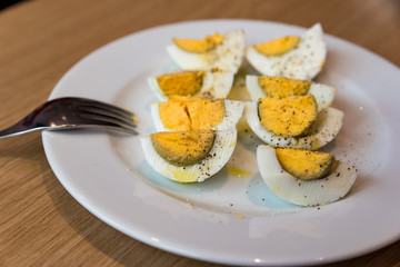 Boiled eggs with salt pepper and olive oil