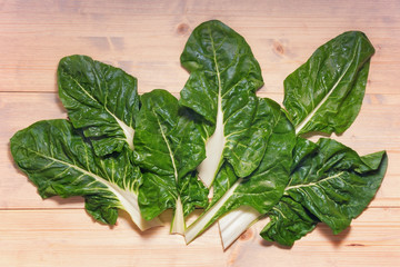 Blitva ( chard leaves ) - popular leafy vegetables in Balkan cuisine. White rustic background, flat lay