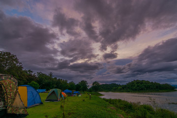 Tent spots along the reservoir in the middle of the forest Resting place cludy sky rain coming