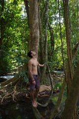 One young man relaxing in the calm of nature, tropical forest beauty. Serenity and green concepts