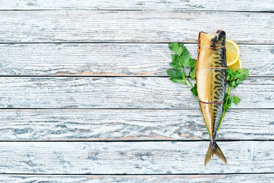 Smoked fish Mackerel. On a white wooden background. Top view.