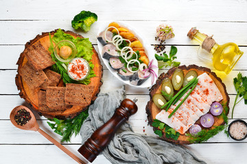 Dishes Ukrainian Traditional Cuisine. Fish, lard, bread and mustard. On the old background. free copying space.