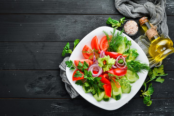 Fresh vegetables sliced in a plate. On the old background. free copying space.