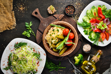 Set salads and pickled vegetables on a plate. On the old background. free copying space.