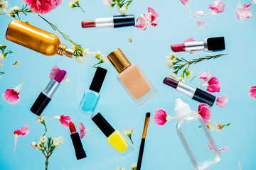 Color lipsticks, perfume, cream and chamelaucium flowers