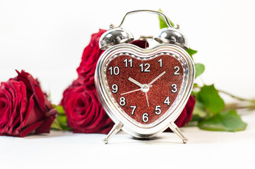 Heart-shaped alarm clock. Place for text. Time for love and greetings.