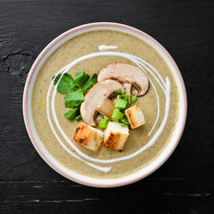 Cream soup of mushrooms in a bowl with toasted bread. Dietary food. Top view.