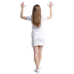 Woman in white t-shirt and skirt standing hands up on white background isolation, back view