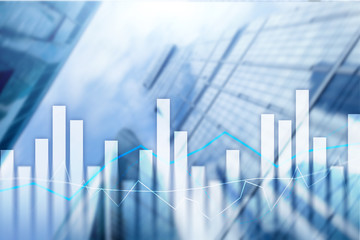Financial graphs and charts on blurred business center background. Invesment and trading concept.