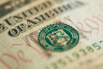 Green stamp on dollar banknote