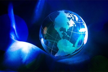 Glass globe ball in light rays on background