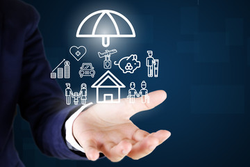 Businessman. Holding car , house , life ,healthcare , family , travel insurance icon..