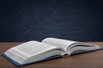 Open book on old wooden table